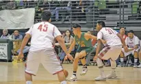  ?? MICHAELA MEANEY/THE NEW MEXICAN ?? Pecos’ Xavier Padilla, center, moves through traffic against Bernadillo’s Chris Garcia, right and Mariano Lovato on Friday in the Ben Luján Tournament in Jacona.