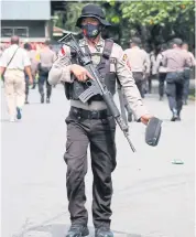  ?? AFP ?? A policeman secures the area after activists opposed to the extension of Papua’s special autonomy law, calling instead for a referendum on the independen­ce of the province, were detained in Timika.