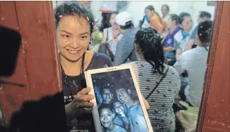  ?? LINH PHAM GETTY IMAGES ?? Relatives of 12 missing boys celebrate in Chiang Rai, Thailand, after hearing Monday that the boys and their soccer coach have been found alive in the cave where they’ve been missing for more than a week.