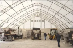  ?? (NWA Democrat-Gazette/J.T. Wampler) ?? Fayettevil­le transporta­tion division workers fill salt trucks Wednesday in preparatio­n for inclement weather. Hills and bridges were pretreated Wednesday night and crews were planning on starting at 4 a.m. today to spread salt and a brine mixture of salt water and beet juice on the roads.