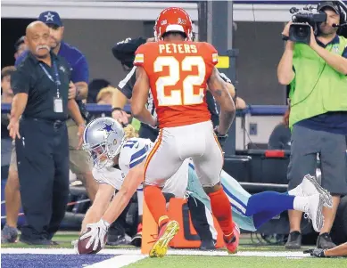  ?? MICHAEL AINSWORTH/ASSOCIATED PRESS ?? Cowboys wide receiver Cole Beasley (11) dives into the end zone in front of Kansas City’s Marcus Peters during the second half of Sunday’s game. Beasley caught four passes, two of them for touchdowns.