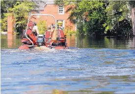  ?? GERALD HERBERT/ASSOCIATED PRESS ?? A swift rescue boat motors through floodwater­s in the aftermath of Hurricane Florence in Nichols, S.C., on Friday. Virtually the entire town is flooded and inaccessib­le except by boat, just two years after it was flooded by Hurricane Matthew.