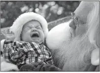  ??  ?? As they have
for decades, parents continue to torture their small children by plopping them down in the laps of scary, hairy old geezers at the mall. This photo will come back to haunt this boy from Texas.