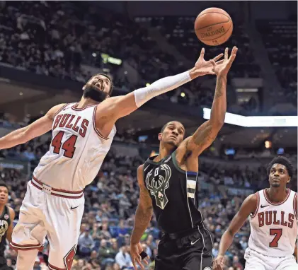  ?? BENNY SIEU/USA TODAY SPORTS ?? Chicago Bulls forward Nikola Mirotic (left) and Bucks guard Gary Payton II reach for a rebound in the third quarter at the BMO Harris Bradley Center on Friday night.