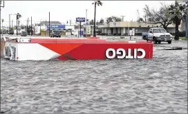  ?? ERIC GAY / ASSOCIATED PRESS ?? The roof of a gas station sits in floodwater­s in the wake of Hurricane Harvey on Saturday in Aransas Pass, Texas. Harvey rolled over the Texas Gulf coast, smashing homes and businesses and lashing the shore with wind and rain.