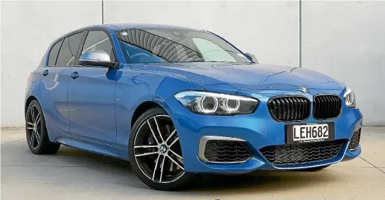  ?? DAMIEN O’CARROLL DAMIEN O’CARROLL ?? Yes, it’s just a humble hatchback. But BMW’s M140i gives the M2 coupe a run for its money (or much less money). A chunky steering wheel and the latest iDrive system, but the interior is looking a bit dated.