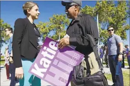  ?? Irfan Khan Los Angeles Times ?? KATIE HILL, a former executive director of a homelessne­ss nonprofit, meets a visitor at a rally for the candidate in the 25th Congressio­nal District in Palmdale.