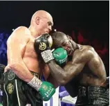  ?? AL BELLO/GETTY IMAGES VIA AFP ?? JILID KEDUA: Tyson Fury (kiri) melayangka­n pukulan ke wajah Deontay Wilder dalam pertarunga­n kedua mereka di Las Vegas (22/2).