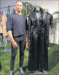  ?? AP PHOTO ?? Fashion designer Laquan Smith stands in New York with his jumpsuit and trench coat created for a small collection inspired by the film “Black Panther.”
