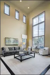  ??  ?? The family room features large windows and high ceilings.