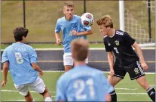  ?? KYLE FRANKO — TRENTONIAN PHOTO ?? Hopewell Valley’s Zach Crow (21) heads the ball to a teammate as he’s surrounded by Princeton defenders during Monday’s game.