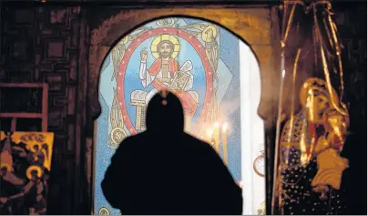  ?? AP FILE PHOTO ?? A priest leads prayers prior to Christmas Eve Mass at the Virgin Mary church, in Cairo, Egypt, Jan. 6, 2018.