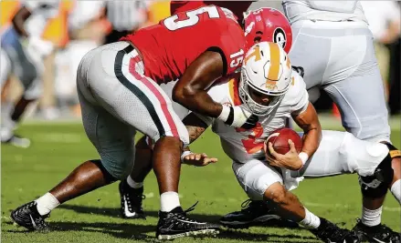  ?? CURTIS COMPTON / CCOMPTON@AJC.COM ?? Georgia linebacker D’Andre Walker sacks Tennessee’s Jarrett Guarantano during the second quarter of Saturday’s game in Athens. UGA sealed the 38-12 win with a 13-play, 75-yard drive in the fourth quarter.