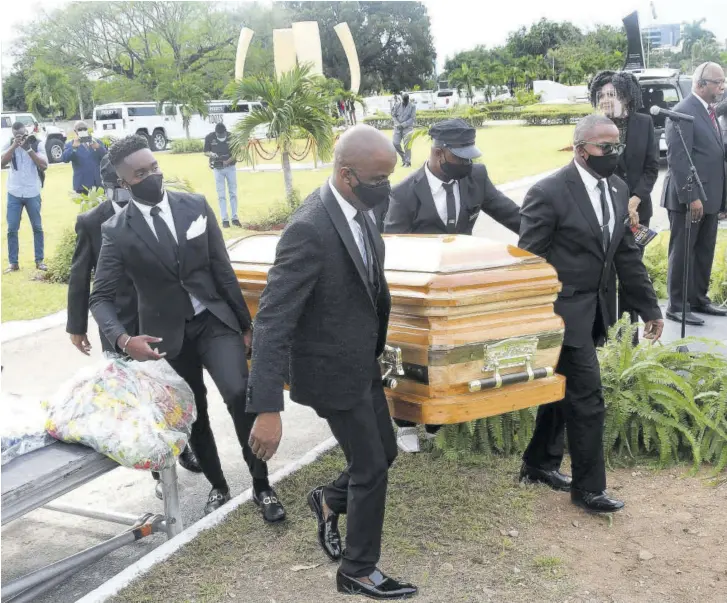  ?? (Photo: Naphtali Junior) ?? Pall-bearers carry the casket bearing the remains of reggae singer Toots Hibbert to its final resting place in the National Heroes’ Park in Kingston yesterday morning.