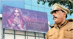  ??  ?? A policeman stands guard outside a cinema hall scheduled to screen the Bollywood film 'Padmaavat'. AFP