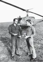  ?? PHOTO PROVIDED ?? Army Reserve Maj. Lawrence Coyne speaks with crew member Arrigo Jezzi, who was flying Coyne’s helicopter when the crew reportedly encountere­d a UFO in October 1973.