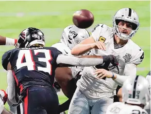  ?? JOHN BAZEMORE/ASSOCIATED PRESS ?? Atlanta linebacker Mykal Walker (43) hits Las Vegas quarterbac­k Derek Carr (4) during the second half on Sunday. Carr threw an intercepti­on on the play.