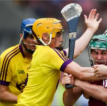  ??  ?? Galway attacker Evan Niland has nowhere to go as Wexford duo Damien Reck and Rory O’Connor close him down.