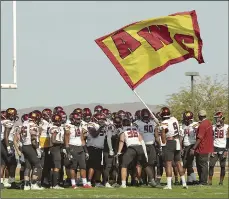  ??  ?? Arizona Western College’s Jaylin Bannerman(9) waves an AWC flag as he and his teammates prepare for the start of Saturday’s 10th annual El Toro Bowl against Lackawanna College at Veterans Memorial Stadium. PHOTO RANDY HOEFT, YUMA SUN