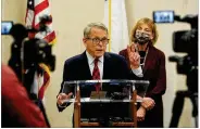  ??  ?? Gov. Mike DeWine visits a vaccinatio­n site Monday in Harrison Twp. “It is pretty universal that the people who are getting the shots are very happy,” he says.