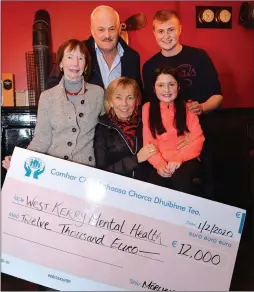  ??  ?? John Griffin, Tom Slattery of Corca Dhuibhne Macra na Feirme, and Áine Ní Dhúbhda presenting a cheque for €12,000 to Annette Cremin and Máire Treasa Ní Chonchúir of West Kerry Mental Health in the Marina Inn on Saturday night. The money was part of the total of €26,000 raised for charities by the West Kerry Tractor Run held on December 1.