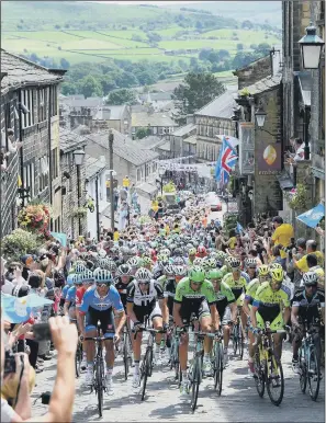  ?? PICTURES: PA WIRE. ?? AGENCY SUCCESS: The Tour de France passes through Haworth, Yorkshire in 2014.