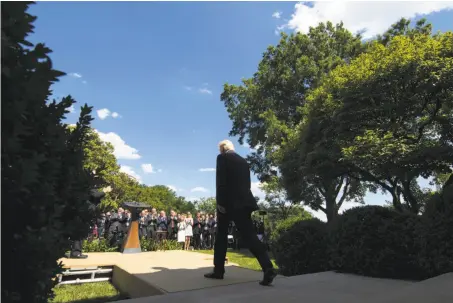  ?? Doug Mills / New York Times ?? President Trump walks to a White House gathering Thursday to announce his plan to withdraw the U.S. from the climate pact.