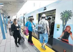  ?? Mel Melcon Los Angeles Times ?? PASSENGERS board an eastbound Expo Line train in Santa Monica. Taking Metro “should be a convenienc­e,” says L.A. Mayor Eric Garcetti.