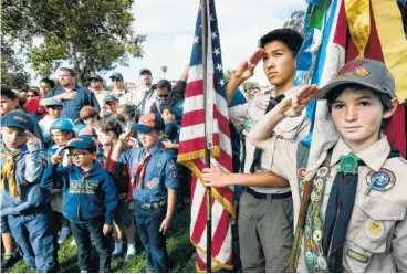  ?? ASSOCIATED PRESS FILE PHOTO ?? Boy Scouts and Cub Scouts salute the flag during Memorial Day weekend ceremonies at the Los Angeles National Cemetery. Boy Scouts of America and the Summit Bechtel Reserve are teaming up for a new national education program for young hunters.