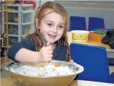  ?? MICHELLE ALLENBERG/ WELLAND TRIBUNE ?? St. Alexander Catholic Elementary School student Hailey Tallman, 4, mixes a batch of dough to be used to make dog treats for a fundraiser to support Welland and District Humane Society.