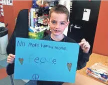  ?? MARTIN RICHARD FOUNDATION ?? Eight-year-old Martin Richard, the youngest person killed in the 2013 marathon bombing, holds up a message of peace.