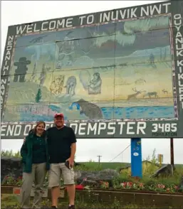 ??  ?? Parks Canada’s Sarah Culley and Guy Theriault at the Inuvik welcome sign.