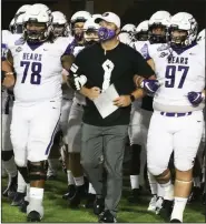  ?? (Photo courtesy University of Central Arkansas) ?? Coach Nathan Brown (middle) walks with his team locked arm-inarm onto the field Saturday before the Bears’ game against Austin Peay at the Cramton Bowl in Montgomery, Ala.