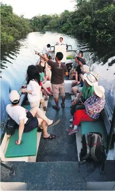  ?? G ADVENTURES ?? Exploring the Amazon on a riverboat jungle skiff.