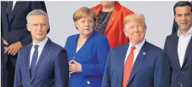  ?? MARLENE AWAAD/BLOOMBERG ?? NATO Secretary General Jens Stoltenber­g, left, German Chancellor Angela Merkel and President Donald Trump stand for a photo at the NATO summit on Wednesday.