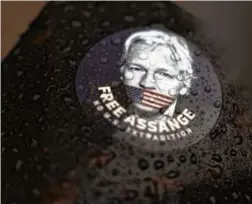  ?? DANIEL LEAL/AFP VIA GETTY IMAGES ?? A sticker calling for the release of WikiLeaks founder Julian Assange was pictured in London on Feb. 21, on the second day of a UK appeal by Assange against his extraditio­n to the United States.