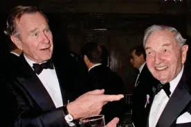  ??  ?? Friends in high places: The billionair­e, right, and George Bush Snr