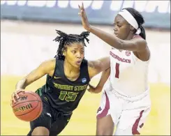  ?? Stephen Spillman / Associated Press ?? Wright State guard Angel Baker drives around Arkansas guard Marquesha Davis during the second half of their first-round game Monday.