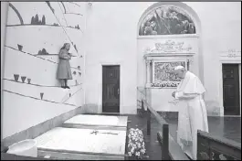  ?? AFP ?? Pope Francis prays in front of the grave of young shepherds Jacinta and Francisco Marto at the Shrine of Our Lady of Fatima in Portugal yesterday.