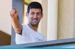  ?? —AFP ?? ADELAIDE: Men’s world number one tennis player Novak Djokovic of Serbia gestures from his hotel balcony in Adelaide yesterday, one of the locations where players have quarantine­d for two weeks upon their arrival ahead of the Australian Open tennis tournament in Melbourne.