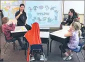  ?? PROVIDED TO CHINA DAILY ?? Zheng Xuan teaches Chinese Sign Language at the Metro Deaf School in Saint Paul, Minnesota.