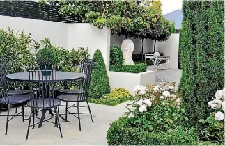  ?? JULIET NICHOLAS/STUFF TESSA CHRISP/STUFF ?? Furniture that looks light and airy allows the eye to travel through and makes a small courtyard feel more spacious. Hard landscapin­g delineates different areas in this courtyard garden; the painted pergola provides shade for the dining table.