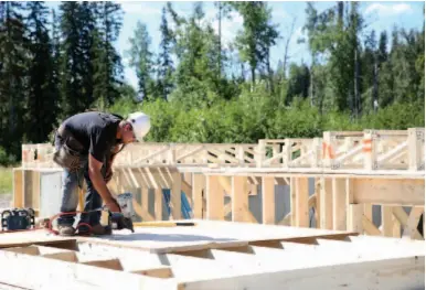  ?? CITIZEN FILE PHOTO ?? Alex Dondale works a nail gun while building a house in Creekside Properties last July.