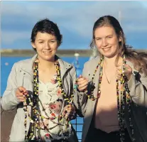  ??  ?? Courage . . . Sisters Hailey (left), and Tyla Crossan hold a necklace made of beads that represent every procedure Hailey underwent in her fight against leukaemia, including a bone marrow transplant from Tyla.