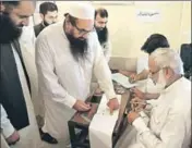  ?? AP ?? n JamaatudDa­wa chief Hafiz Saeed casts his vote in Lahore.