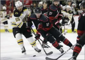  ?? GERRY BROOME - THE ASSOCIATED PRESS ?? Boston Bruins’ Noel Acciari (55) chases the puck with Carolina Hurricanes’ Andrei Svechnikov (37), of Russia, during the first period in Game 4 of the NHL hockey Stanley Cup Eastern Conference final series in Raleigh, N.C., Thursday, May 16, 2019.