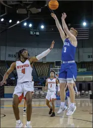  ?? Photo By: Aaron Witt ?? Cole Cathcart takes a Mump shot in the quarterfni­nals game against Wewoka.