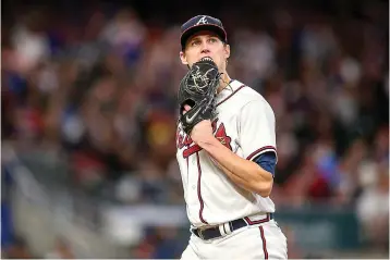  ?? ?? Atlanta Braves starting pitcher Kyle Wright (30) walks off the field in the fifth inning of a baseball game against the New York Mets on Oct. 1, 2022, in Atlanta. The Braves have reason to hope that Wright, the majors' only 20-game winner last season, still has time to be ready for the regular season. If Wright requires more time to prepare for his first start, the Braves appear to be developing sufficient depth to fill their rotation. (AP Photo/Brett Davis, File)