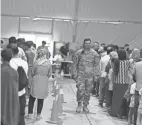  ?? DAVID GOLDMAN/AP ?? Afghan refugees line up last week for food at Fort Bliss’ Doña Ana Village, where they are being housed in Chaparral, N.M.