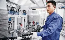  ?? Elringklin­ger AG ?? An Elringklin­ger employee works in Suzhou, China. Workers in San Antonio may soon be making products for Tesla vehicles.